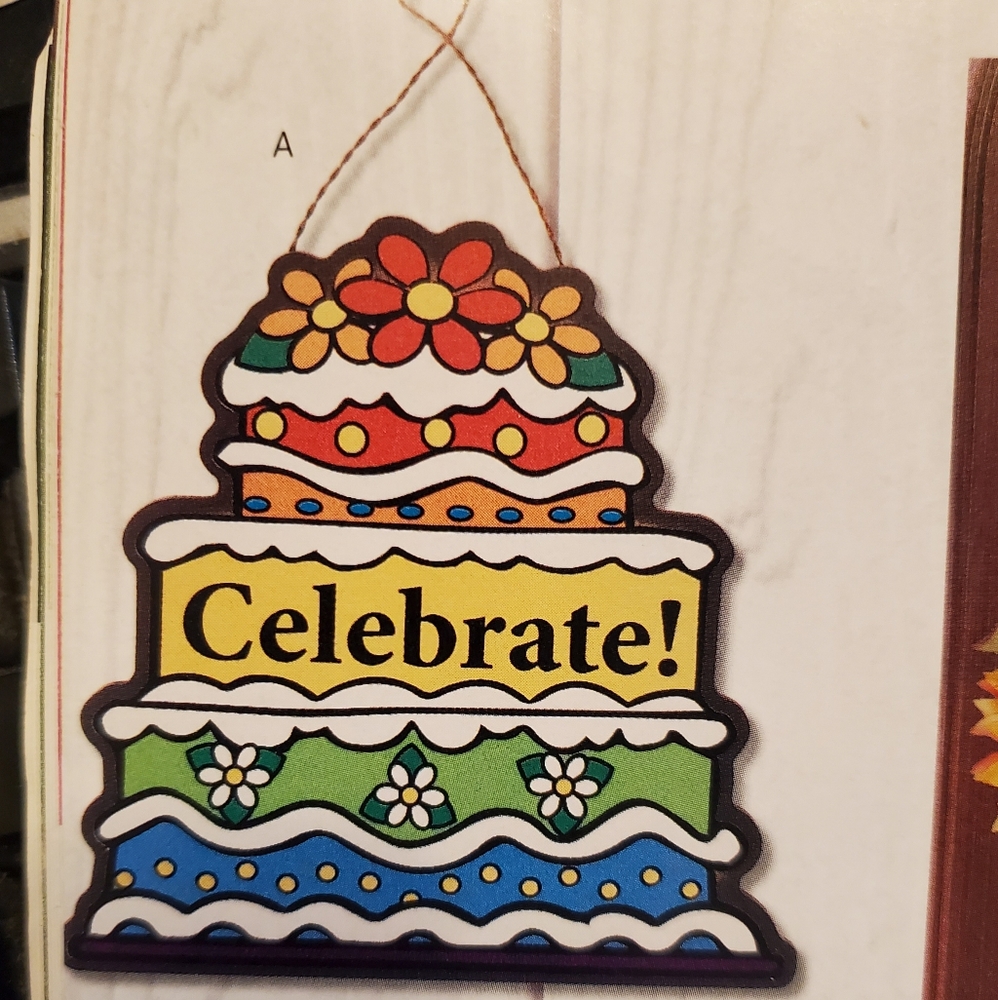 Celebrating Home Birthday cake door plaque. Shaped like a cake. New. 8" x 8"